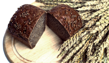 fresh bread and ears of wheat, isolated against white backgroundの写真素材
