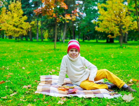 happy boy in the autumn parkの写真素材