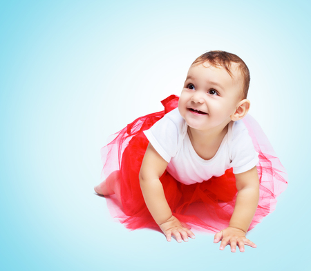 portrait of a cute baby, isolated against blue backgroundの写真素材