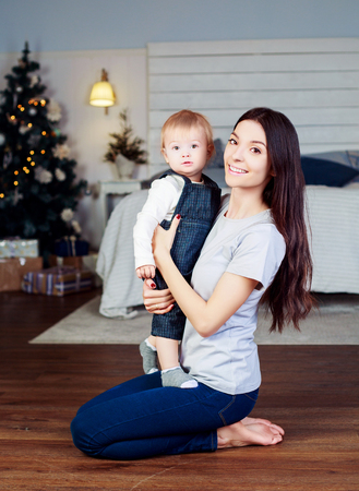 happy mother and baby hugging and laughing at homeの写真素材