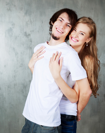 happy young couple hugging and kissing  の写真素材