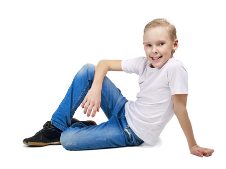 happy smiling nine years old boy, isolated against white backgroundの写真素材