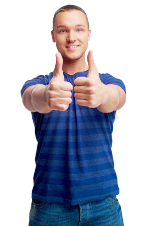 portrait of a young man showing thumbs up  isolated against white backgroundの写真素材
