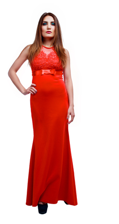 beautiful  oung  woman,wearing a long red dress,  isolated against white backgroundの写真素材