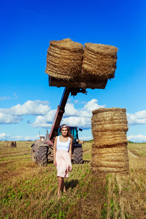 beautiful woman in the harvested  wheat field in august on a sunny dayの写真素材