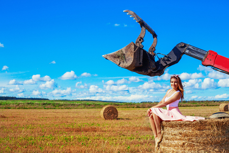 beautiful woman in the harvested  wheat field in august on a sunny dayの写真素材