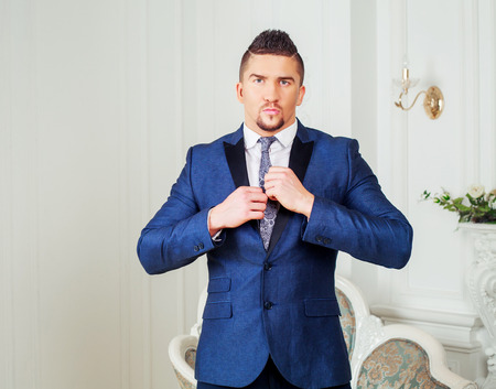 stylish man wearing a suit in the interiorの写真素材