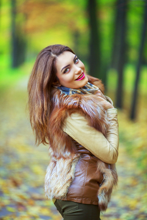 beautiful young woman   in the autumn park outdoorの写真素材