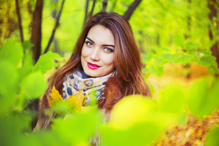 beautiful young woman   in the autumn park outdoorの写真素材