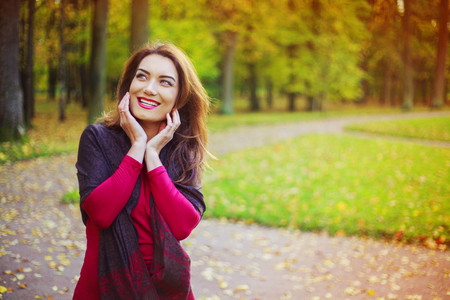 beautiful young woman in the autumn parkの写真素材