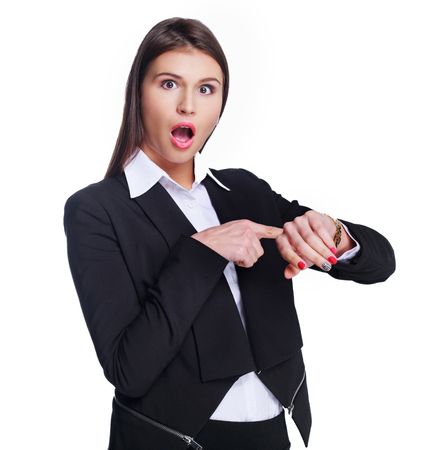 beautiful young businesswoman looking at her watch against white backgroundの写真素材
