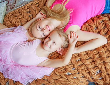 happy young beautiful mother and daughter at homeの写真素材