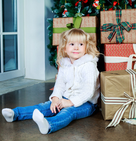 happy girl  at home with Christmas tree and presentsの写真素材