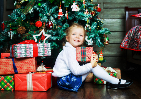 happy girl at home with Christmas presentsの写真素材
