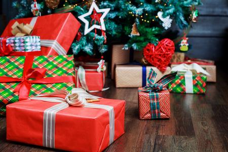 Christmas tree and many colorful gifts under it, on the Christmas Eveの写真素材