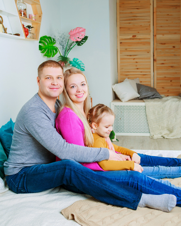 happy young parents with a child  at homeの写真素材