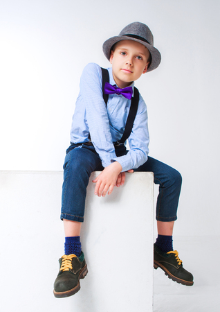  stylish boy wearing a hat and a tie, against white backgroundの写真素材