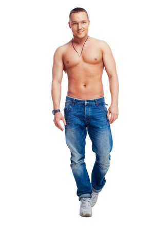 portrait of a muscular young; man taking off his shirt isolated against white backgroundの写真素材