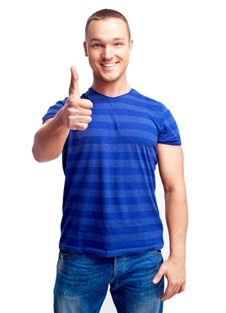 portrait of a young man showing thumb up  isolated against white backgroundの写真素材