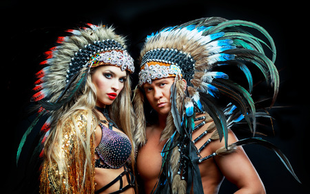 beautiful manand woman, striptease dancers wearing  Native American costumesの写真素材