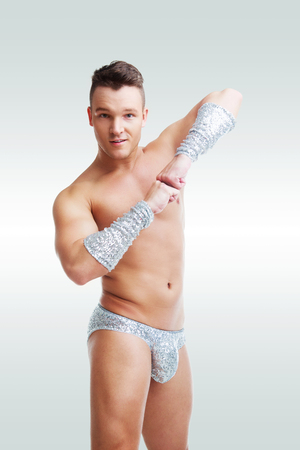 striptease dancer wearing sparkling costume in the studio isolated against white backgroundの写真素材
