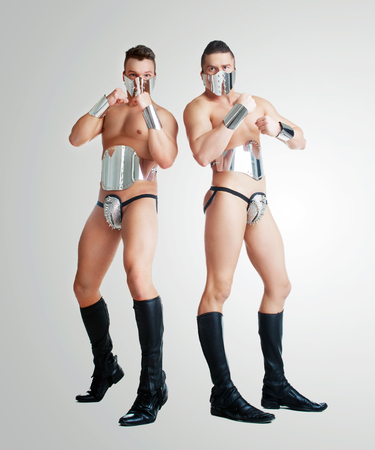 striptease dancers wearing  sparkling silver costumes in the studio isolated against white backgroundの写真素材