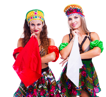 two beautiful women striptease dancers performing russian traditional folk dance, isolated against whiteの写真素材