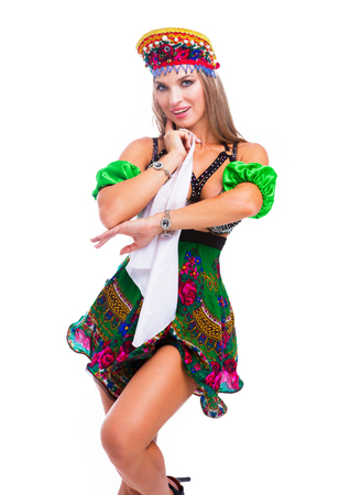 beautiful woman striptease dancer performing russian traditional folk dance, isolated against whiteの写真素材