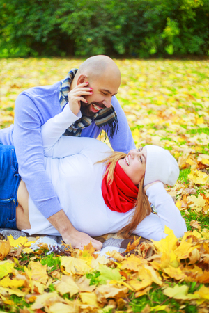 happy young couple walking and having fun in the autumn parkの写真素材