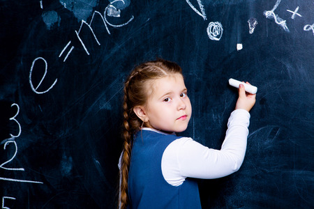little girl   at school against chalkboardの写真素材