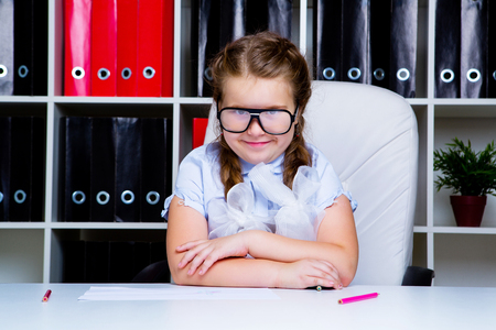 happy little schoolgirl doing homework at homeの写真素材