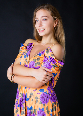 attractive  young woman  wearing a  dress  in the studioの写真素材