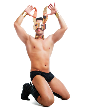 striptease dancer wearing underwear and face mask with rabbit ears in the studio isolated against white backgroundの写真素材