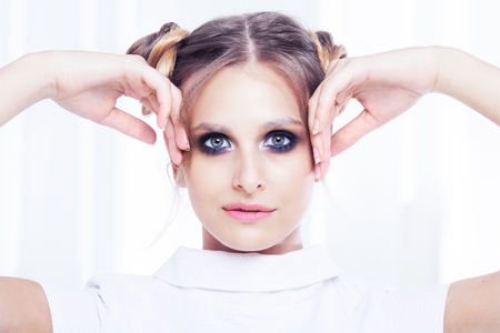 beautiful  young blond woman with sparkling silver makeup   posing  in the  studioの写真素材