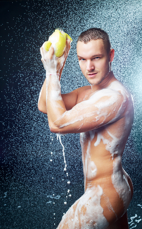 a handsome muscular attractive young man taking showerの写真素材