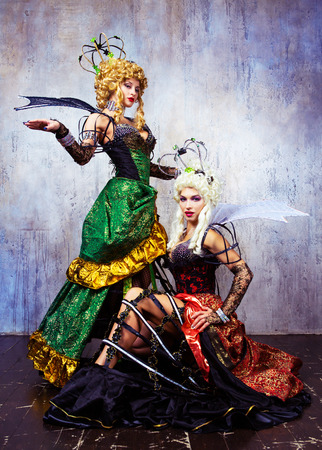 beautiful sexy young models wearing Halloween costume of a queen, in the studioの写真素材