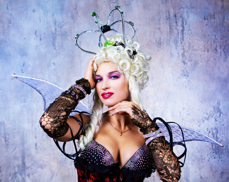beautiful sexy young model wearing Halloween costume of a queen, in the studioの写真素材