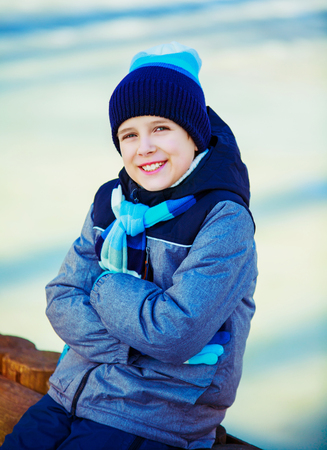 happy cute boy outdoor in the winter parkの写真素材