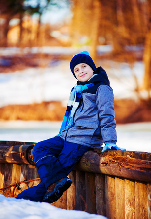 happy cute boy outdoor in the winter parkの写真素材