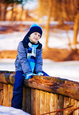 happy cute boy outdoor in the winter parkの写真素材