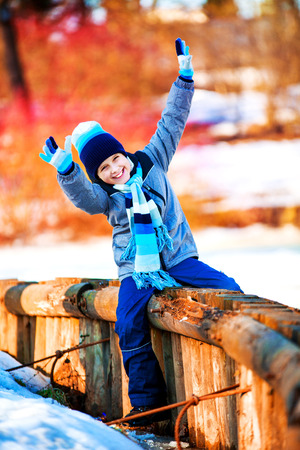 happy cute boy outdoor in the winter parkの写真素材