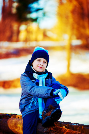 happy cute boy outdoor in the winter parkの写真素材
