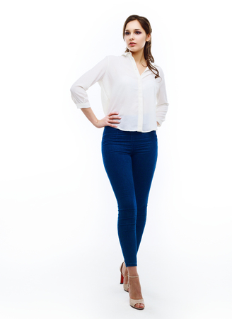 beautiful young woman, isolated against white studio backgroundの写真素材