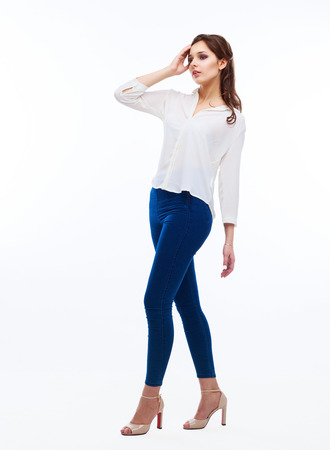 beautiful young woman, isolated against white studio backgroundの写真素材