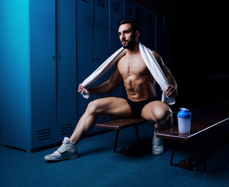 handsome muscular athletic man  in the locker room after working outの写真素材