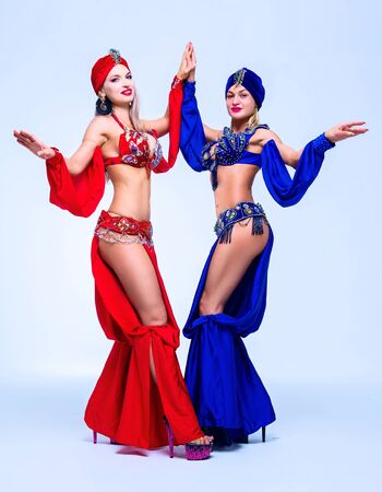 beautiful sexy women wearing  stage costumes of a belly-dancers, in the studioの写真素材