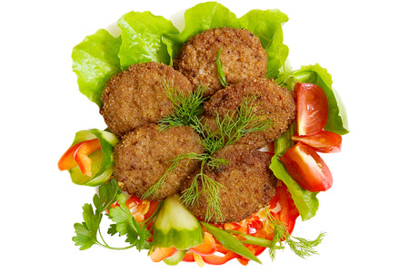 Fried cutlets with vegetables and greens on a white background, isolatedの写真素材