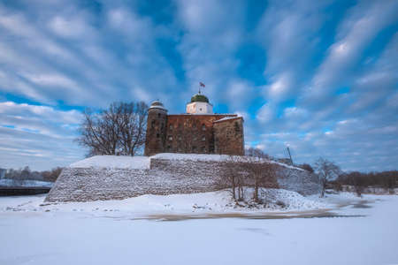 Castle in the city of Vyborg in winter over epic cloudsのeditorial素材