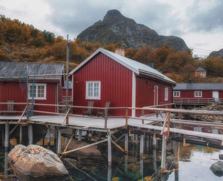 September 20, 2019 Norway Lofoten Islands, empty fishing town of Nusfjord, Traditional wooden, red, houses on stilts in the water.のeditorial素材