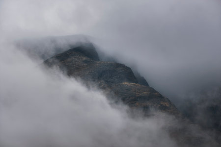 Old gloomy northern mountains in the clouds